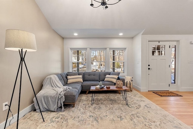 living room with baseboards, wood finished floors, and recessed lighting