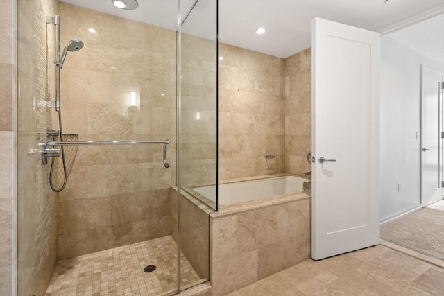 bathroom featuring separate shower and tub