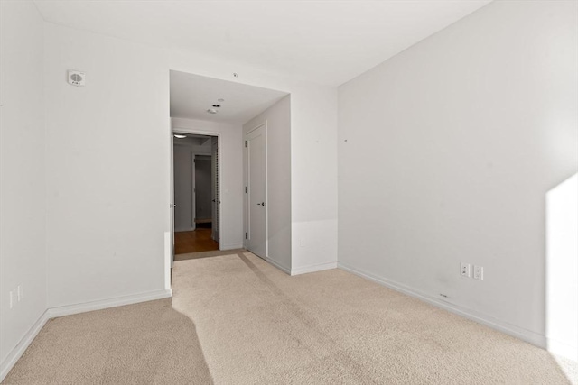 empty room featuring light colored carpet