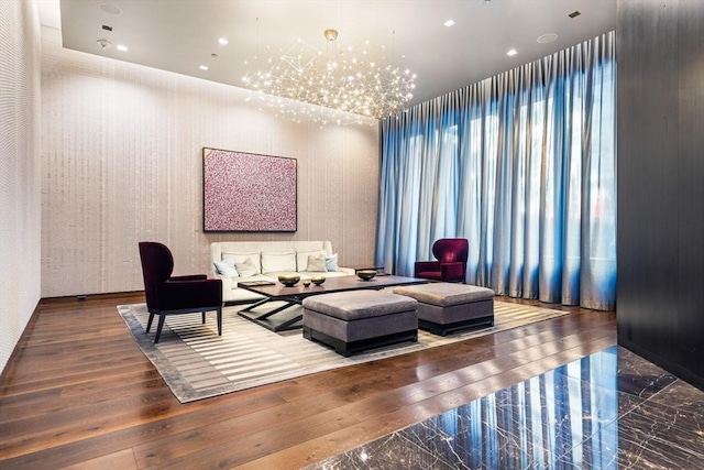 living room with hardwood / wood-style flooring and a chandelier