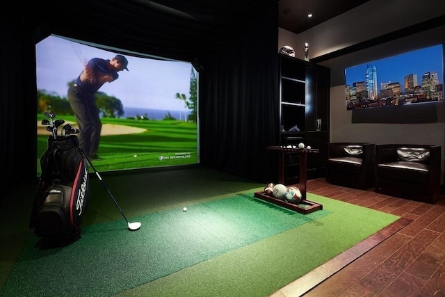 recreation room featuring golf simulator and dark wood-type flooring