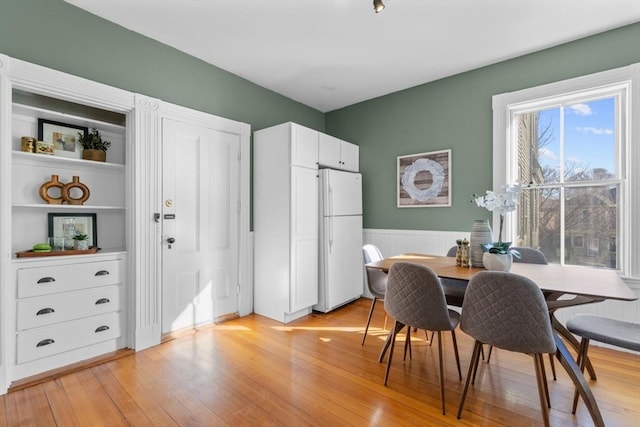 dining area with light hardwood / wood-style floors