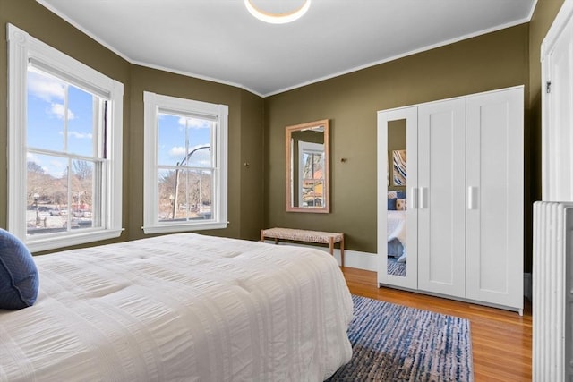 bedroom featuring crown molding and hardwood / wood-style floors