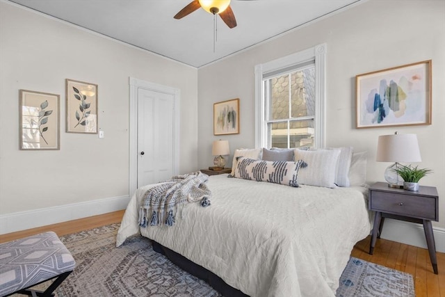 bedroom featuring hardwood / wood-style floors and ceiling fan