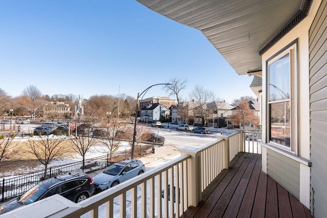 view of snow covered back of property