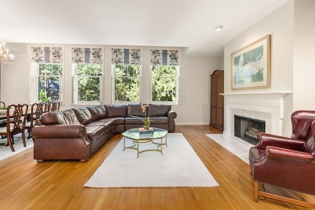 living room with a notable chandelier and light hardwood / wood-style flooring