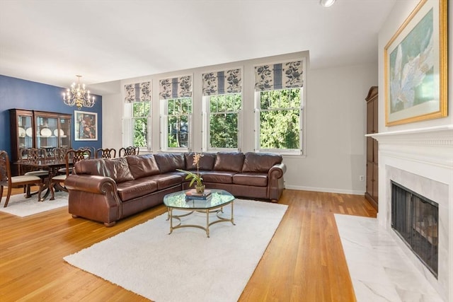 living room featuring a notable chandelier and light hardwood / wood-style flooring