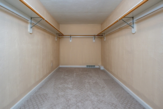 spacious closet with carpet and visible vents