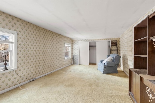 unfurnished room with plenty of natural light, carpet, baseboards, and wallpapered walls