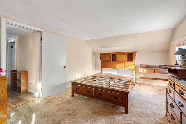 bedroom with baseboards and vaulted ceiling