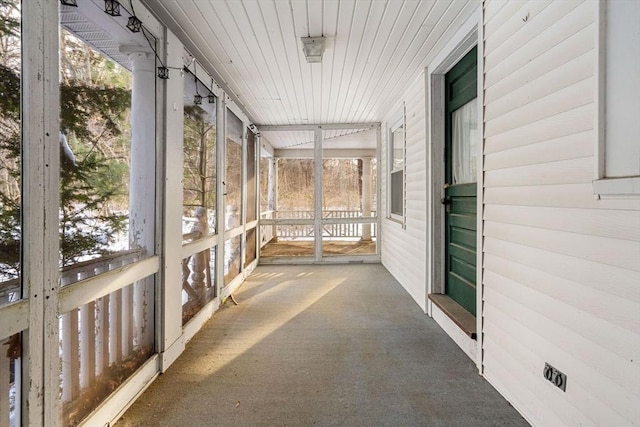 unfurnished sunroom featuring plenty of natural light