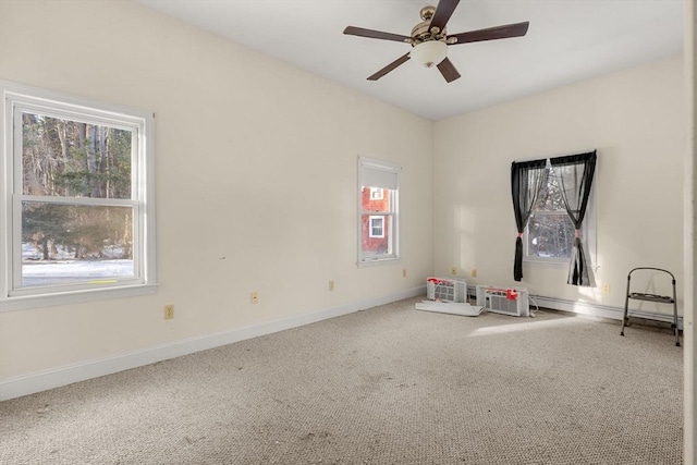 interior space featuring plenty of natural light, carpet, baseboards, and ceiling fan