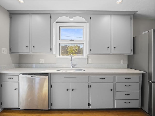 kitchen with recessed lighting, light countertops, gray cabinets, a sink, and stainless steel appliances