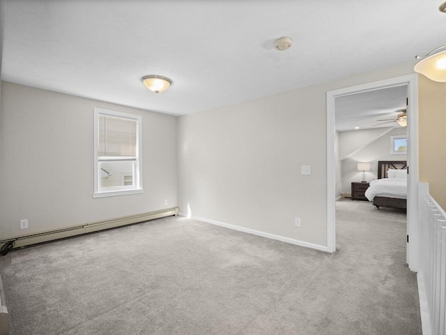 unfurnished bedroom featuring baseboards, baseboard heating, and carpet flooring