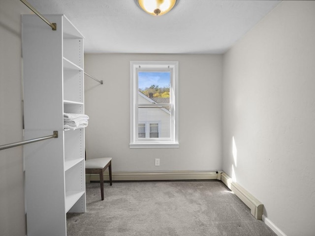 walk in closet with carpet and baseboard heating