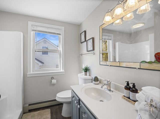 full bath featuring vanity, toilet, baseboards, wood finished floors, and a baseboard radiator