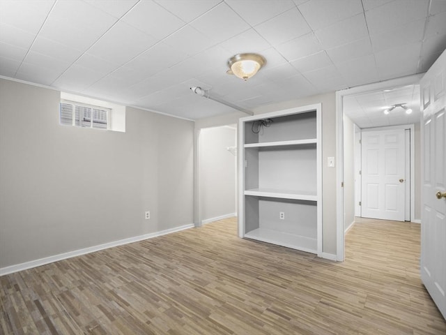 unfurnished bedroom featuring baseboards, visible vents, light wood finished floors, and a closet