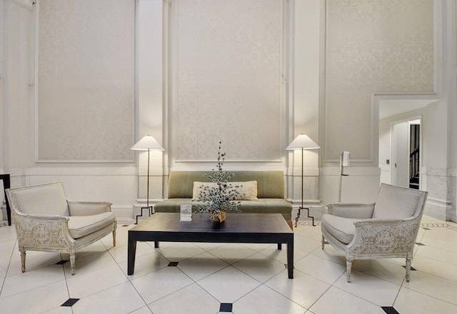 sitting room with tile patterned flooring and a towering ceiling
