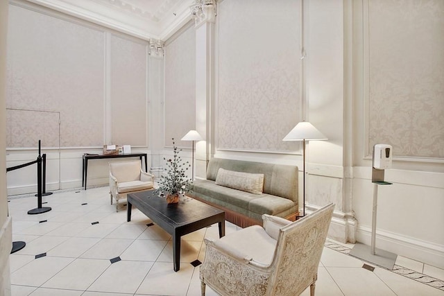 common area featuring a decorative wall, a wainscoted wall, and wallpapered walls