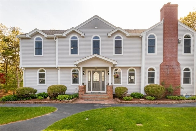 87 Lewis Point Rd, Bourne, MA 02532 - view of front of property with a front yard and a chimney