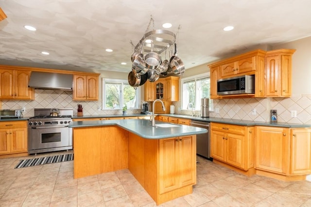 87 Lewis Point Rd, Bourne, MA 02532 - kitchen with stainless steel appliances, wall chimney exhaust hood, healthy amount of natural light, a kitchen island with sink, and recessed lighting