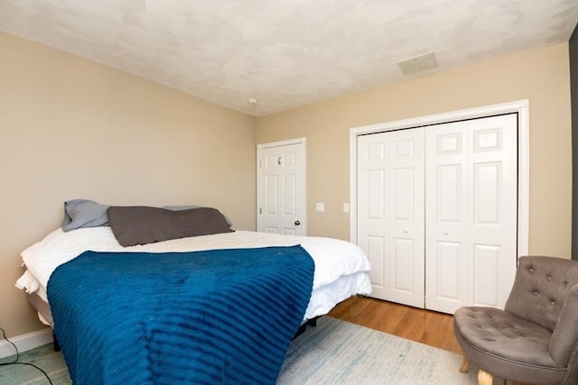 87 Lewis Point Rd, Bourne, MA 02532 - bedroom with a closet, wood finished floors, and baseboards
