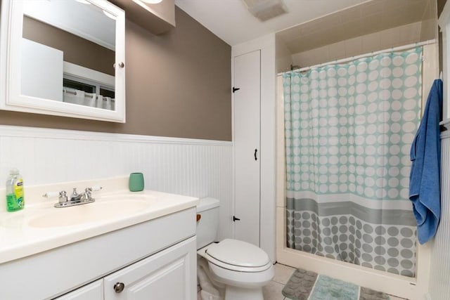 87 Lewis Point Rd, Bourne, MA 02532 - full bath with a shower with shower curtain, a wainscoted wall, vanity, toilet, and tile patterned flooring
