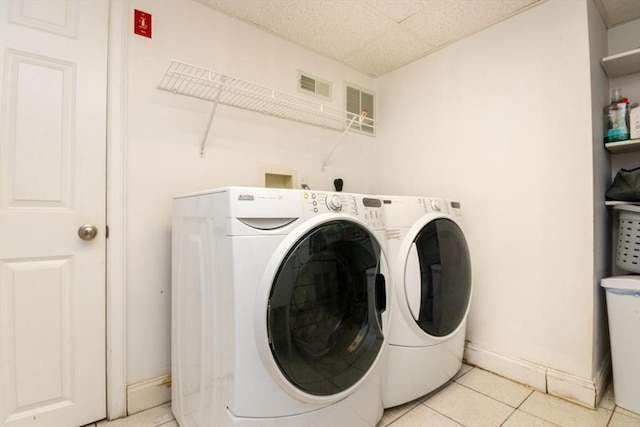 87 Lewis Point Rd, Bourne, MA 02532 - washroom featuring washer and clothes dryer, light tile patterned flooring, and baseboards