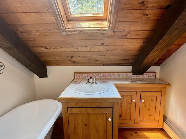 1962 Shelburne Falls Rd, Conway, MA 01341 - bathroom with a soaking tub, vanity, a skylight, wood finished floors, and a wood ceiling with exposed beams