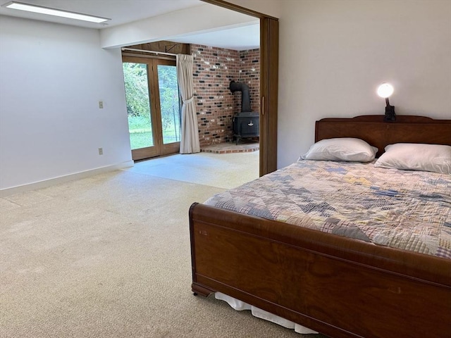 1962 Shelburne Falls Rd, Conway, MA 01341 - carpeted bedroom featuring a wood stove and access to outside