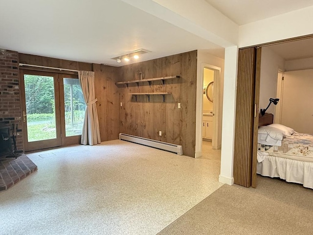 1962 Shelburne Falls Rd, Conway, MA 01341 - living room with baseboard heating, a wood stove, and wooden walls