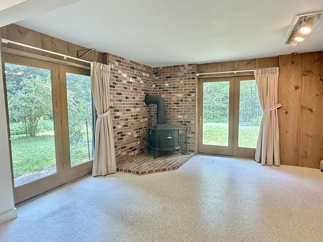 1962 Shelburne Falls Rd, Conway, MA 01341 - unfurnished living room with a wood stove and wooden walls