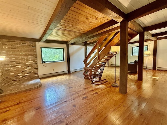 1962 Shelburne Falls Rd, Conway, MA 01341 - additional living space featuring baseboard heating, light wood-style flooring, a baseboard heating unit, stairway, and brick wall