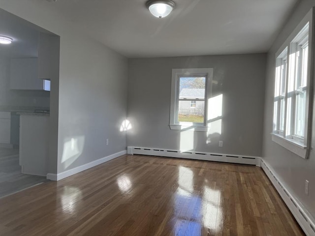 spare room featuring plenty of natural light and a baseboard radiator