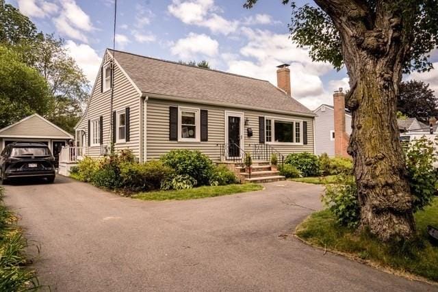 58 Lakeshore Ave, Beverly, MA 01915 - view of front of house with a chimney, a garage, an outdoor structure, and asphalt driveway