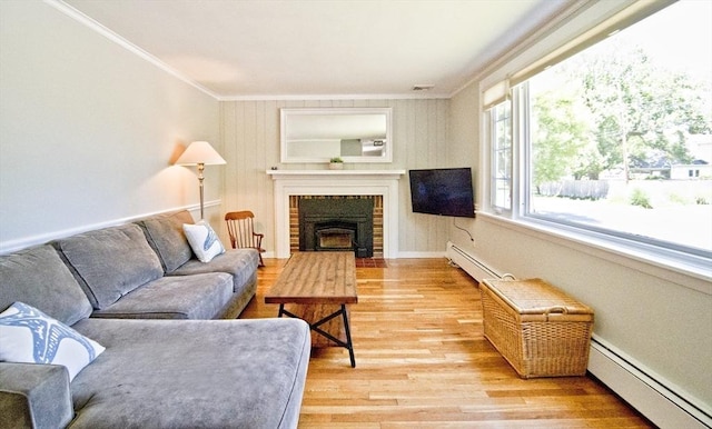 58 Lakeshore Ave, Beverly, MA 01915 - living room with baseboard heating, crown molding, light wood-style flooring, and a brick fireplace