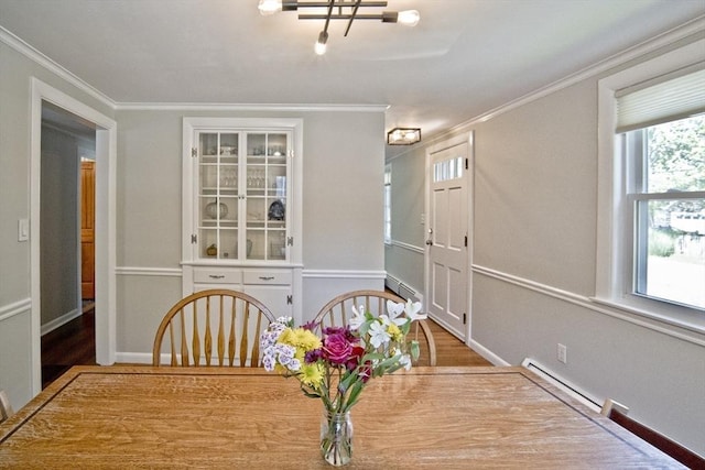 58 Lakeshore Ave, Beverly, MA 01915 - unfurnished dining area with ornamental molding, a baseboard heating unit, wood finished floors, and a baseboard radiator