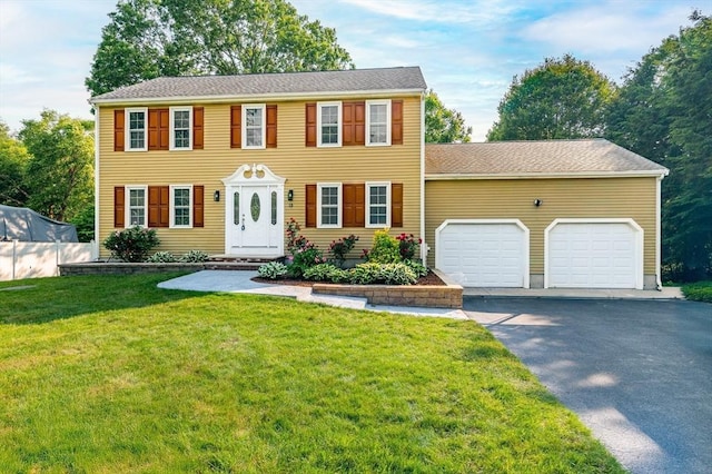 13 Laura Ln, Norton, MA 02766 - colonial-style house with a garage, asphalt driveway, and a front yard