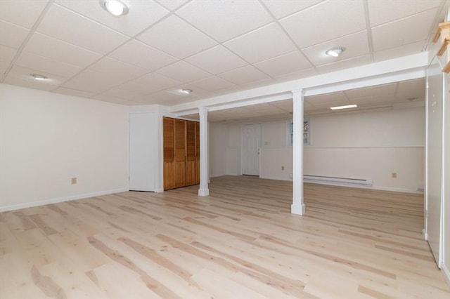 13 Laura Ln, Norton, MA 02766 - finished below grade area with a baseboard heating unit, light wood finished floors, and a paneled ceiling