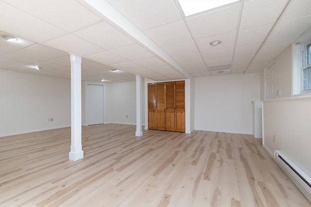13 Laura Ln, Norton, MA 02766 - finished below grade area featuring a baseboard heating unit, wood finished floors, and a drop ceiling