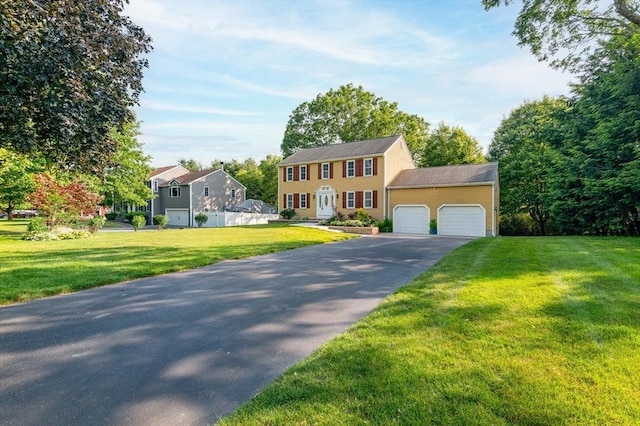 13 Laura Ln, Norton, MA 02766 - colonial-style house with a garage, asphalt driveway, and a front yard