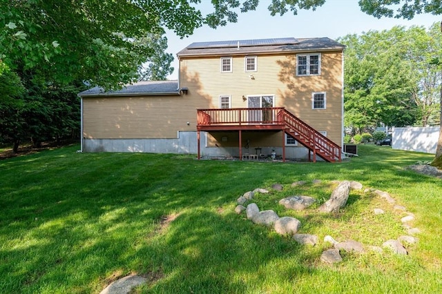 13 Laura Ln, Norton, MA 02766 - back of house featuring a wooden deck, stairs, roof mounted solar panels, and a yard
