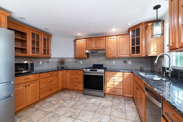 13 Laura Ln, Norton, MA 02766 - kitchen featuring appliances with stainless steel finishes, under cabinet range hood, brown cabinets, decorative light fixtures, and glass insert cabinets