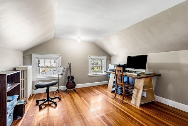 office featuring baseboards, wood finished floors, and lofted ceiling