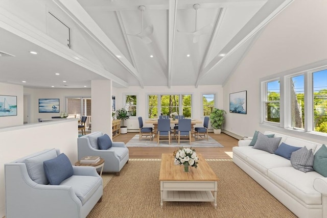 living area with high vaulted ceiling, beam ceiling, recessed lighting, light wood finished floors, and baseboard heating