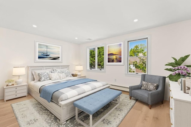 bedroom featuring a baseboard radiator, light wood-type flooring, and recessed lighting