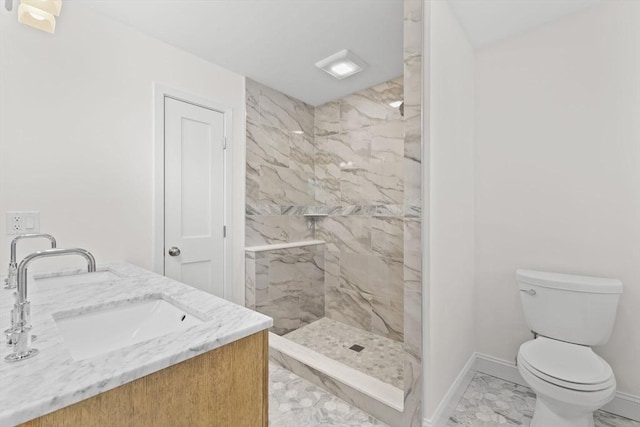 bathroom featuring marble finish flooring, baseboards, tiled shower, toilet, and double vanity