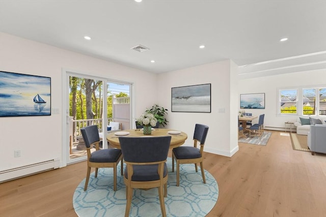dining space with light wood finished floors, healthy amount of natural light, baseboard heating, and recessed lighting