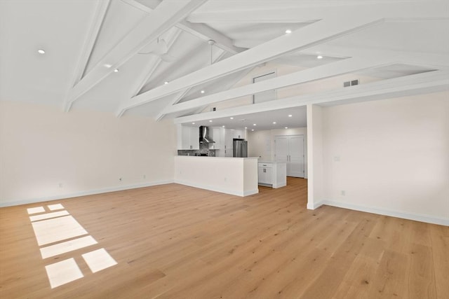 unfurnished living room featuring recessed lighting, light wood-style flooring, and baseboards
