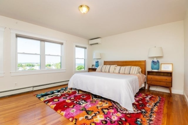 15 Dundee Rd, Quincy, MA 02171 - bedroom with a wall unit AC, wood finished floors, a baseboard heating unit, and baseboards